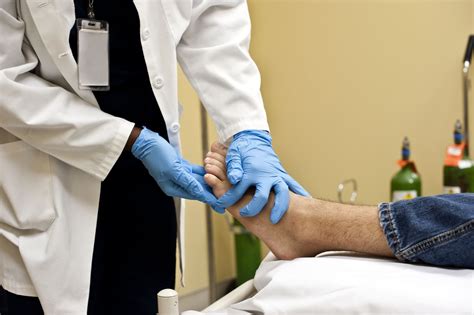 Podiatric Surgeon Examining Foot