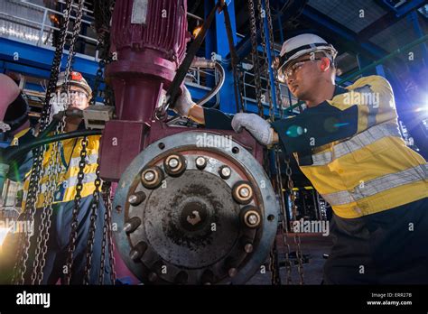 Electricians performing routine maintenance tasks in a power plant