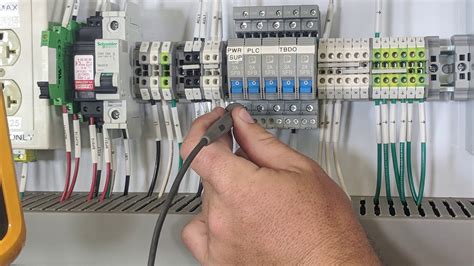 Electricians troubleshooting electrical issues in a power plant