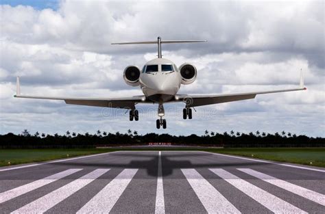 Private jet landing on a runway