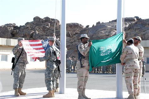 Saudi Arabian and US military personnel cooperating at a military base in Saudi Arabia