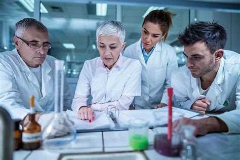 Scientists reading research papers in a library