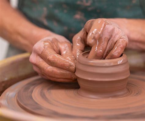 Shaping red clay into calendar form