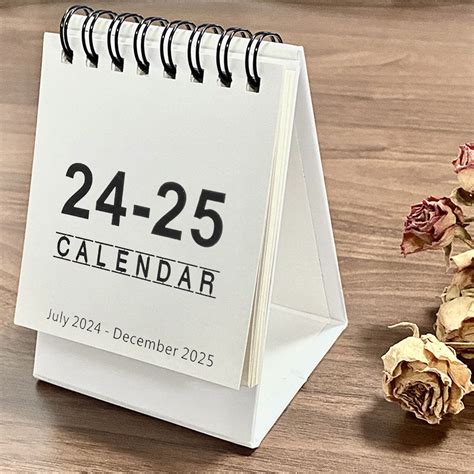 Small desk calendar on a wooden desk