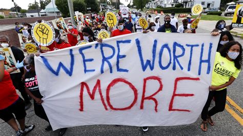 People holding signs that read 'Equality Now'