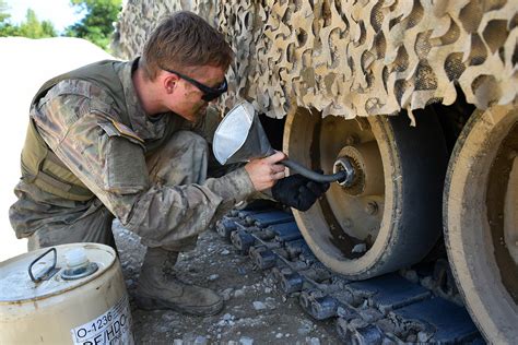 A soldier maintaining equipment