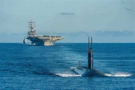 Submarine and aircraft carrier in action