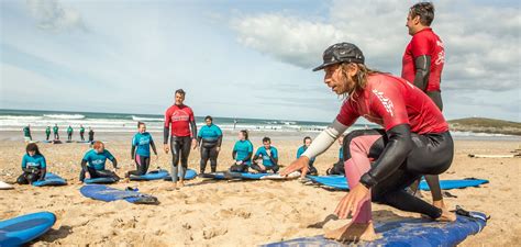 Surf instructor teaching a student how to catch a wave