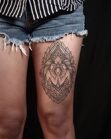 Symbolic thigh tattoo design