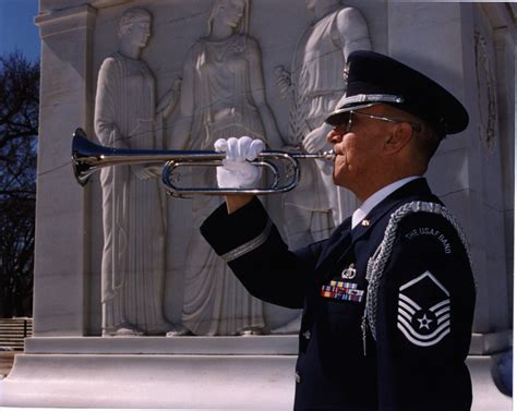 A bugler plays Taps at a funeral service