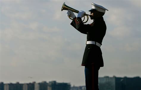 A bugler plays Taps at a military funeral