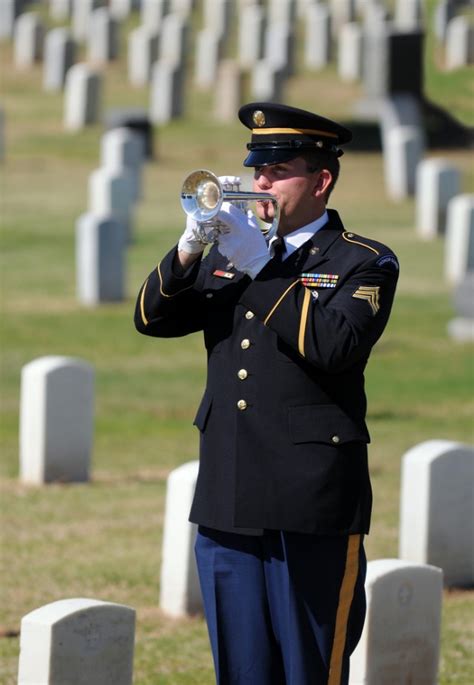 A bugler plays Taps at a military funeral