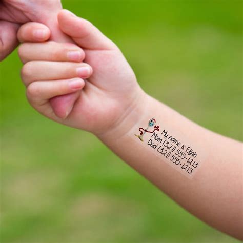 A person applying a temporary tattoo