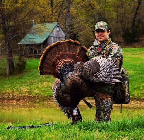 A picture of a hunter with a wild turkey