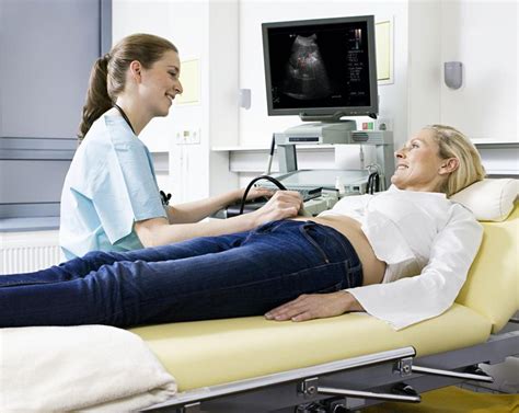 Ultrasound Technician Helping Patient