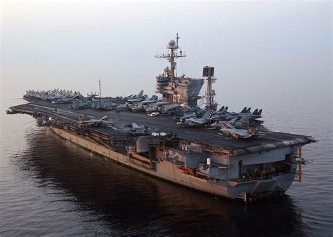 USS John F. Kennedy (CV-67) with the American flag