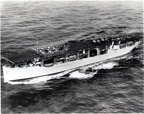 A biplane taking off from the USS Langley