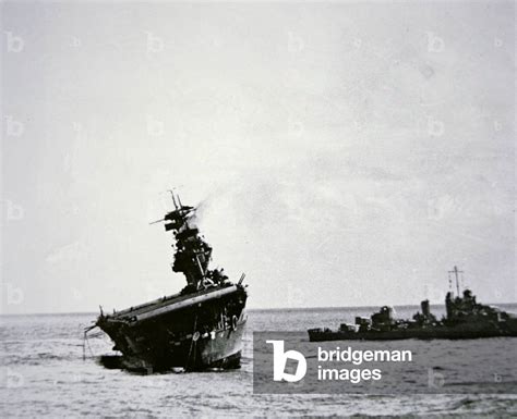 The USS Yorktown listing heavily after being torpedoed by a Japanese submarine