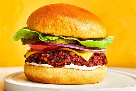 Veggie burger on a whole grain bun with sweet potato fries