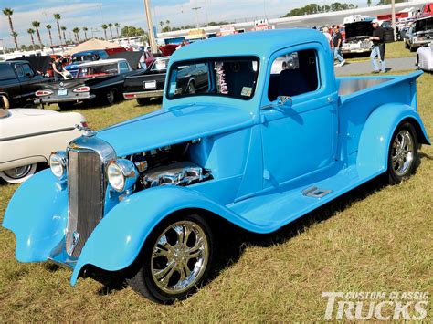 A vintage chicken feed truck on display at a classic car show