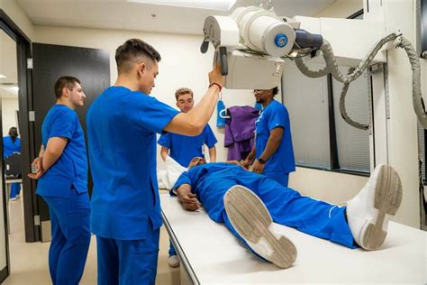 X-ray technician preparing patient for imaging procedure