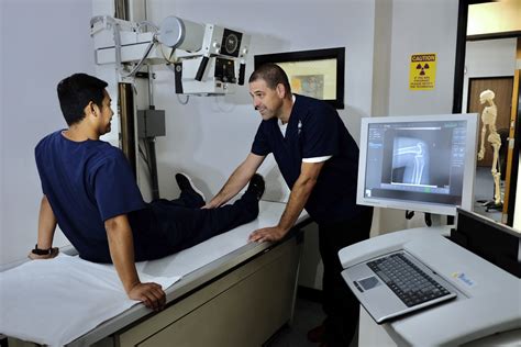 X-ray technician operating X-ray machine