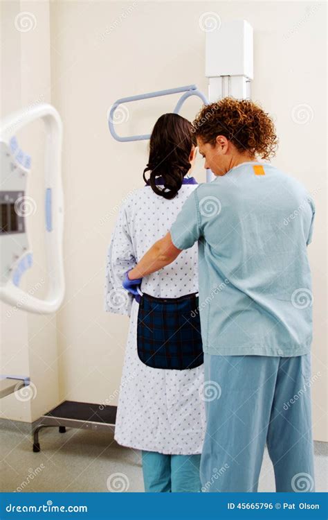 X-ray technician preparing patient for imaging procedure