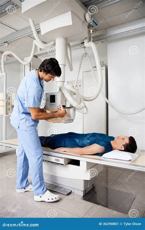 X-ray technician operating X-ray machine